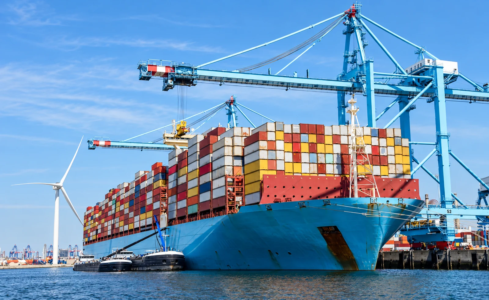 Container cargo vessel at a seaport with gantry cranes